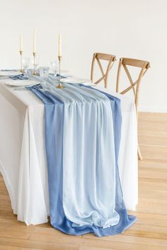 the table is set with blue and white linens