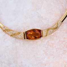 This remarkable necklace is centered with one (1) rectangular cushion cut natural citrine set into a bezel setting. The necklace is also accented with one hundred twenty (120) bead set, round brilliant cut diamonds and thirty- seven (37) channel set, round brilliant cut fancy colored diamonds. The necklace measures 16.8mm wide at the center and tapers to 5.8mm wide along the omega style chain. The necklace measures 17 inches in length and is finished with a box clasp and safety. Rectangular Cushion, Pearl Necklace Designs, Citrine Pendant, Diamond Necklace Set, Bead Set, Box Clasp, Natural Citrine, Fancy Color Diamonds, Channel Set