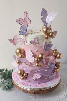 a three tiered cake with butterflies on it