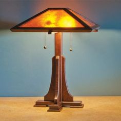 a wooden table lamp with a stained glass shade