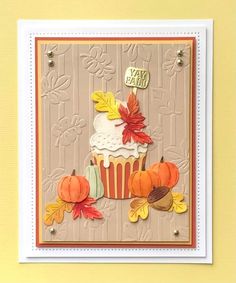 a card with a cupcake and fall leaves on it