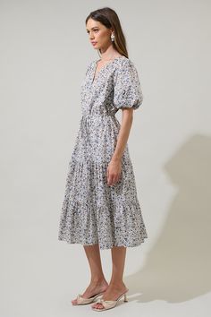 This adoreable floral midi dress will have you beaming! With its tiered skirt, draw string waist, and split neck, you're sure to look sharp on your next garden stroll. Plus, the ditsy floral print will bring a dose of charm to any daytime look. - Tiered skirt- Draw string waist- Split neck detail- Ditsy floral print- Color: Cream MultiSize + Fit - Model is 5'8" and wearing size XS- Measurements taken from size S - Chest: 20"- Length: 48" Fabric Self:100% Cotton Lining:97% Polyester 3% Spandex St Casual Tiered Dress With Gathered Skirt, Spring Floral Print Prairie Dress, Midi Length, Spring Floral Print Midi Prairie Dress, Spring Floral Print Prairie Dress Midi Length, Spring Tiered Dress With Gathered Skirt, Flowy Tiered Dresses With Gathered Skirt, Spring Dresses With Gathered Skirt And Short Sleeves, Summer Floral Print Midi Prairie Dress, Spring Prairie Dress Midi Length For Daywear