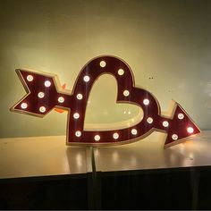 a lighted love sign sitting on top of a table