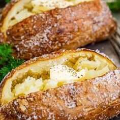 two loaves of bread with cheese and parmesan on top, sitting on a cooling rack