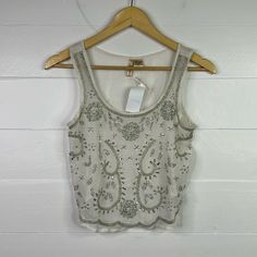 New With Tags! Passport Sleeveless Tank Top Shirt -Size S -Ivory/Off White With Silver Beads & Sequins -Scoop Neck -Semi See-Through -Cropped -100% Polyester -Note: Bead Work Tends To Naturally Have Loose Beads Or Easily Fall Off (Handle With Care) -Only Flaws Is A Small Faint Mark & A Snag As Seen In Pictures Measurements Laying Flat: Bust 16” Length 16.5” Bb12 Embellished Summer Vest, Sleeveless Embellished Beige Top, Beige Embellished Sleeveless Top, White Tank Top For Party, White Sequined Tank Top For Spring, Embellished Fitted Sleeveless Blouse, Spring White Sequined Tank Top, White Beaded Top For Party, Embellished Fitted Sleeveless Tank Top