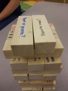 several blocks of wood stacked on top of each other with chinese characters written on them