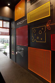 the wall is decorated with many different colors and shapes, including red, yellow, orange, and black