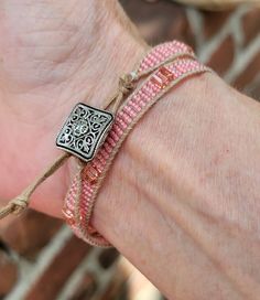 This dainty, pink bracelet is made from pink seed beads and pink crystal cubes. It has a square, silver, Victorian style button as a closure. It runs a little small, so be aware that at its longest length it's only 14 inches long. It can also be worn as a choker. Adjustable Pink Beaded Bracelet With Silver Beads, Handmade Pink Wrap Bracelet With Round Beads, Pink Wrap Bracelet With Round Beads For Gifts, Adjustable Pink Jewelry With Silver Beads, Adjustable Pink Beaded Wrap Bracelet, Adjustable Pink Bohemian Wrap Bracelet, Bohemian Adjustable Pink Wrap Bracelet, Adjustable Bohemian Pink Wrap Bracelet, Beaded Pink Wrap Bracelet Gift