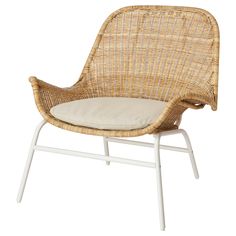 a wicker chair with a cushion on the back and white legs, against a white background