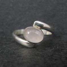 This beautiful estate ring is sterling silver with a 6x8mm rose quartz gemstone. The face of this ring measures 7/16 of an inch north to south. Size: 9 Marks: 925 Condition: Excellent Turtle Brooch, Estate Ring, Silver Gift Wrap, Solitaire Rings, Estate Rings, Rose Quartz Ring, Rose Quartz Gemstone, Green Enamel, Quartz Ring