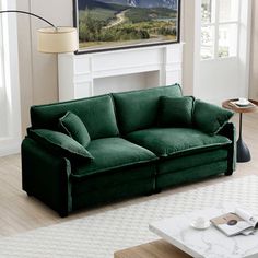 a living room with a green couch and coffee table