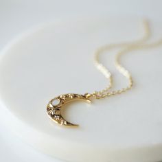 "Beautiful and lovely dainty moon necklace. Made of opal stone and CZ stone gold color moon pendant with skinny gold plated brass chain. Soft and simple. Great for gift, everyday or special occasion. Your item will ship in a gift box. Please feel free to contact me if you have any questions. ♥ Chain length 14\" - 20\" ♥ Moon pendant 5/8\" x 3/4\" ♥ Gold plated over brass / Opal stone ♥ Creation Time: 1 - 3 days ♥ See more Rudiana Accessories Rudiana.etsy.com" Dainty Moon Necklace, Moon Necklace Gold, Golden Moon, Star And Moon Necklace, Gold Moon Necklace, Necklace Opal, Celestial Necklace, Moon Pendant Necklace, Gold Heart Necklace