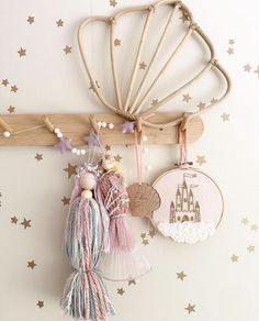 a wall hanging with some tassels attached to it and other decorations on the wall