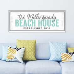 the miller family beach house established 2016 sign is displayed on a wall above a blue couch