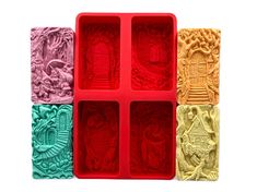 four different colored ice trays with designs on them