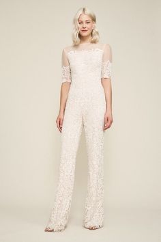 a woman in a white lace jumpsuit