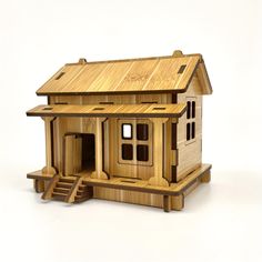 a wooden toy house with stairs leading up to it