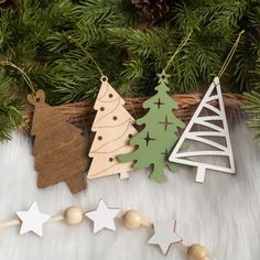 three wooden christmas ornaments hanging from a tree