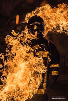 a firefighter with flames in his hands