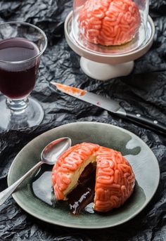 a piece of cake that looks like a brain is on a plate with a spoon