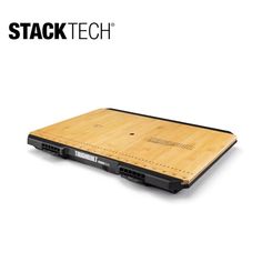 a laptop computer sitting on top of a wooden table next to a white background with the words stack tech written above it