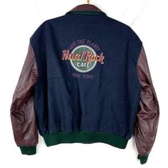 Vintage Hard Rock Cafe Wool Leather Bomber Jacket Large Snap Button Embroidered Size/Measurements (Based in inches) Size - Large Pit to pit - 27" Length - 25" Shoulder to cuff - 24.5" Condition / Details Vintage fading to the original color of the fabric Stains on collar Combined Shipping: We provide combined shipping, please contact us for a quote Retro Outerwear With Embroidered Graphics For Fall, Retro Winter Outerwear With Embroidered Graphics, Retro Fall Outerwear With Embroidered Graphics, Retro Embroidered Fall Outerwear, Retro Embroidered Varsity Jacket For Fall, Embroidered Retro Varsity Jacket For Fall, Vintage Winter Outerwear With Embroidered Graphics, Embroidered Fitted Varsity Jacket For Fall, Cafe New York