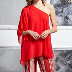 New Badgley Mischka Georgette One Shoulder Top. Size Medium Top, Bright Siam Red In Color, Fully Lined. This Loose Fitting, Breathable Summer Top Will Catch Their Eye As It Playfully Reveals A Single Shoulder. Feminine And Fun, This Top Is Perfect For Lunch Dates And Sunny Days. This Lightweight Blouse Drapes Elegantly From Your Shoulder To Your Upper Thigh, Featuring An Asymmetrical Design. Sheer Layers And Flowing Sleeves Perfect This Look. Perfect For At Home Entertaining Or A Special Night O Elegant Red Top For Evening, Elegant Red Tops For Evening, Elegant Red Evening Top, Elegant Red Party Tops, Chic Red Holiday Tops, Red One-shoulder Party Top, Elegant Red Top For Wedding, Elegant Holiday Cocktail Tops, Flowing Sleeves