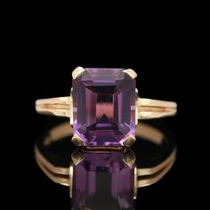 A stunning, emerald-cut amethyst set in a 14k yellow gold split shank ring. Size 6.  Center stone: 9.91 x 8.03 x 5.45 mm. Baguette Cut Amethyst Ring For Formal Occasions, Classic Yellow Gold Rectangular Amethyst Ring, Elegant Rectangular Amethyst Ring In Yellow Gold, Rectangular Amethyst Ring For Formal Occasions, Rectangular Amethyst Ring For Formal Events, Elegant Purple Amethyst Baguette Cut Ring, Elegant Purple Baguette Cut Amethyst Ring, Purple Baguette Cut Rings For Formal Occasions, Octagon-shaped Amethyst Ring For Formal Occasions