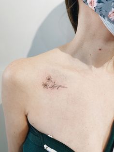 a woman with a flower tattoo on her chest