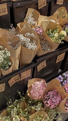 many different types of flowers in brown paper bags