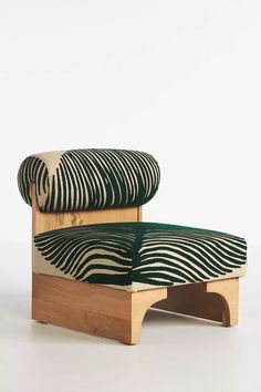 a chair made out of wood with a zebra print upholstered seat and back