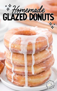 a stack of glazed donuts sitting on top of a white plate with icing