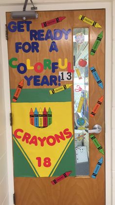 a classroom door decorated with crayons and the words get ready for a colorful year