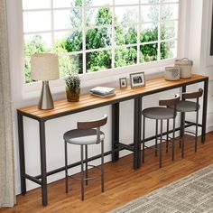 three stools and a table in front of a window