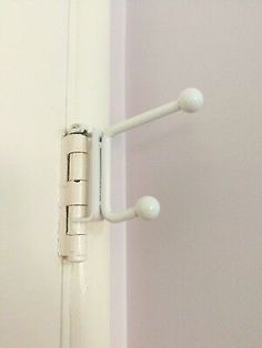 a white door handle is attached to the wall