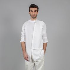 A Dressy Mens White Shirt With An Asymmetrical Button Detail And Banded Collar. Composition: Linen Blend White Stand Collar Top For Summer, White Summer Top With Stand Collar, Casual White Fitted Kurta, Summer Layering Shirt With Buttons, White Semi-formal Top For Summer, Casual Long Sleeve Kurta For Summer, White Stand Collar Tops For Daywear, White Semi-formal Spring Shirt, Long Sleeve Summer Kurta With Buttons