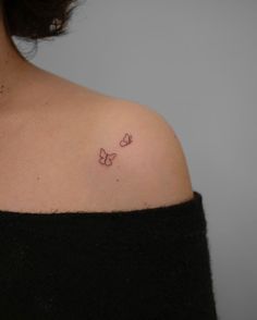 a woman with a small butterfly tattoo on her shoulder