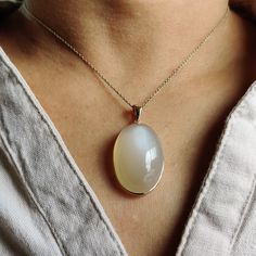 Details of the pendants: White Moonstone Pendant Stone Weight: 29.05 carats Stone size and shape: 20x30 mm & Oval Metal: GOLD Purity: 14K (58.33%) approx Gold Weight: 0.76 grams Gross Weight: 6.57 grams White Moonstone necklace pendant. These pendants are absolutely perfect for daily wear as they are light and definitely stylish. This dainty pendant can be used in layers with other pendants. The initial price is for pendant only, For chain along with the pendant for the necklace, please see the Elegant Oval Necklace With Large Stone, Elegant Moonstone Oval Pendant Jewelry, Elegant Gold Gemstones With Large Stone, Modern White Gold Gemstones For Gift, Elegant Yellow Gold Chalcedony Necklaces, Elegant Oval Pendant Gemstones With Natural Stones, Elegant Chalcedony Jewelry With Polished Finish, Elegant Oval Pendant With Natural Stones, Elegant Sterling Silver Gemstones With Large Stone