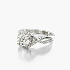 a white gold ring with an oval diamond in the center and two rows of diamonds around it