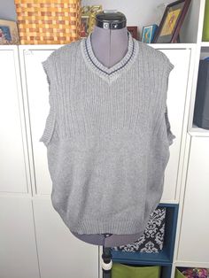 "Vintage early 90's gray cotton sweater vest from J. Riggings, a store that permanently closed in 1998. Excellent vintage condition. Marked a size M but this is VERY stretchy and over sized. Depending on how you want it to fit this can fit any size from M-4X. Check measurements below.  Measurements (unstretched - fully stretched) Bust: 45\"-76\" Length: 26\"" Gray Cotton Sweater Vest For Fall, Casual Gray Crew Neck Vest, Casual Gray Cotton Vest, Casual Gray Crew Neck Sweater Vest, Gray Cotton Sleeveless Sweater Vest, Gray Cotton Casual Sweater Vest, Casual Gray Cotton Sweater Vest, Vintage Gray Cotton Sweater, Gray Sweater Vest