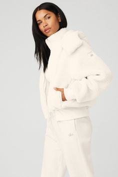 Easy come, easy go. Cut from cozy sherpa and equipped with a removable hood and zip pockets, our ultra-comfy Foxy Sherpa Jacket will get you to the studio every time. Features a front-zip closure, oversized silhouette and ribbed cuffs and hem. On-trend oversized fit Removable hood & zippered pockets Designed to work from studio to street Wear-tested by our in-house team for the perfect fit Cozy White Outerwear With Double-lined Hood, Alo Yoga Hooded Outerwear With Ribbed Cuffs, Hooded Alo Yoga Outerwear With Ribbed Cuffs, Cozy Winter White Fleece Jacket, Alo Yoga Cozy Long Sleeve Outerwear, Cozy Fit White Outerwear With Soft Texture, Cozy Cream Outerwear With Ribbed Cuffs, Alo Yoga Winter Loungewear Outerwear, Cozy Long Sleeve Alo Yoga Outerwear