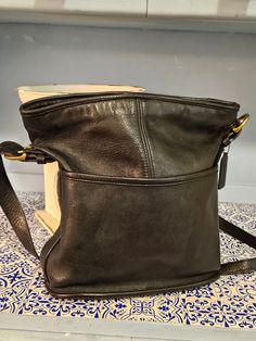 Beautiful vintage Coach bucket bag with a front pocket in excellent vintage condition! Classic Bucket Bag, Classic Bucket Shape Shoulder Bag, Vintage Satchel Bucket Bag Everyday, Vintage Satchel Bucket Bag For Everyday, Vintage Bucket Bag With Removable Pouch, Vintage Leather Bucket Bag With Removable Pouch, Classic Black Bucket Shoulder Bag, Vintage Bucket Bag For Travel, Vintage Bucket Bag For Formal Events