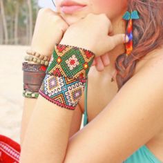 a beautiful young woman wearing a colorful bracelet