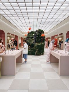 a group of people standing around in a room with many items on the walls and floor