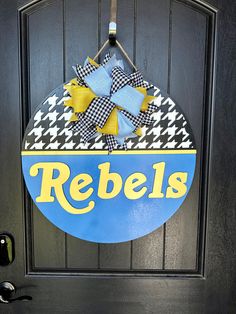 a door hanger that says rebells on it