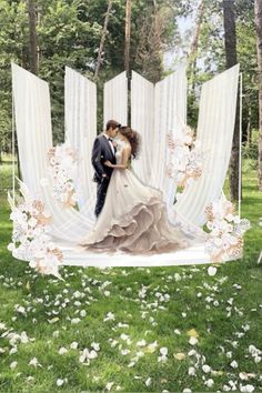 a bride and groom are kissing in front of an outdoor ceremony backdrop with white flowers