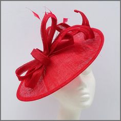 Elegant design disc fascinator/hatinator in red sinamay. Decorated with matching loops of sinamay and feathers. Made on a headband. Ideal for a wedding, Ladies day, race day or other special occasions. This design is available in other colours on request. All of our designs can be made to order in a range of different colours or styles, see our colour chart: https://jacquivaledesigns.co.uk/pages/sinamay-colour-chart Please contact us if you would like a bespoke design to match your outfit. We ma Red Top Hat For Spring Church, Red Top Hat For Spring Church Events, Red Fitted Hat For Gift, Red Fitted Hat As Gift, Red Fitted Hats As Gifts, Red Headpieces For Summer Gifts, Red Headpieces As Summer Gifts, Red Headpieces Suitable For Summer Gifts, Red Hats As Spring Gift