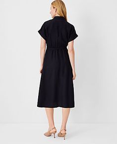 Elevate your wardrobe with the Ann Taylor Crossover Collared Midi Shirtdress, a versatile piece that promises effortless style and comfort. Perfect for a variety of occasions, this dress features a flattering crossover front and a chic point collar.

- **Size:** Regular 00
- **Color:** Black
- **Gender:** Female
- **Material:** Shell: 67% Lyocell, 18% Linen, 15% Viscose; Lining: 100% Polyester
- **Sleeve Length:** Short
- **Length:** 28 inches from natural waist
- **Fit:** Hits below the knee
- Spring Black Belted Dress For Daywear, Black Belted Dress For Spring Daywear, Black Collared Dress With Relaxed Fit, Black Relaxed Fit Collared Dress, Collared Belted Dress With Tie Waist, Black Belted Dress For Spring Workwear, Casual Belted Dress With Tie Waist For Daywear, Fitted Black Belted Dress For Summer, Spring Workwear Black Belted Dress