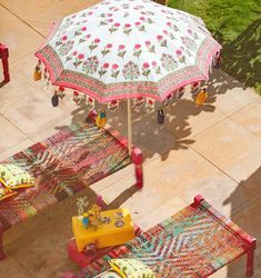 an umbrella and two benches on the ground