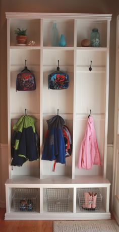 the coat rack is filled with coats and shoes for kids to use in their home